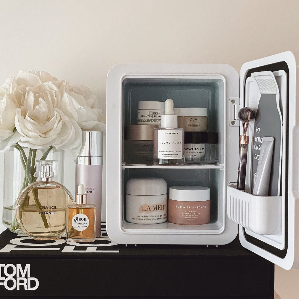 Inside of The Aqua Cosmetics Fridge with luxury skincare products, facial roller, sheet masks