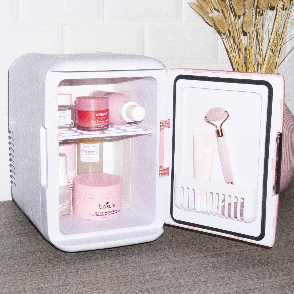 The Cosmo Cosmetics Fridge in Pink with door open showcasing skincare products and pink quartz facial roller