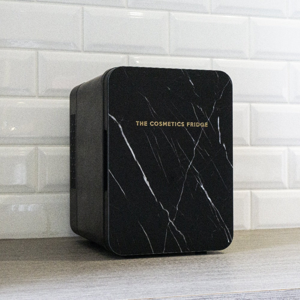 The Black Marble Cosmetics Fridge displayed in a home with white tiles