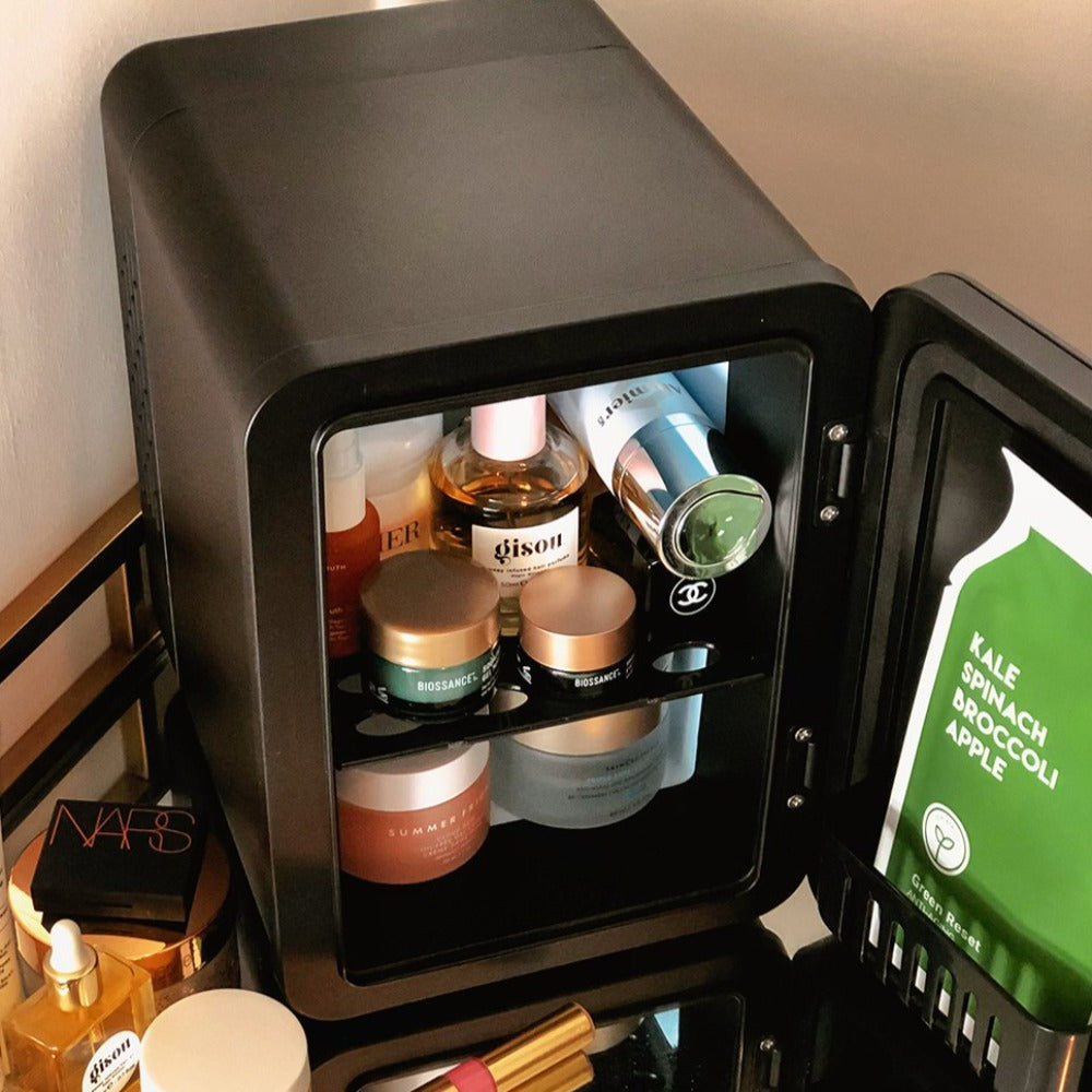 Inside of The Black Marble Cosmetics Fridge with luxury skincare products, facial roller, sheet masks